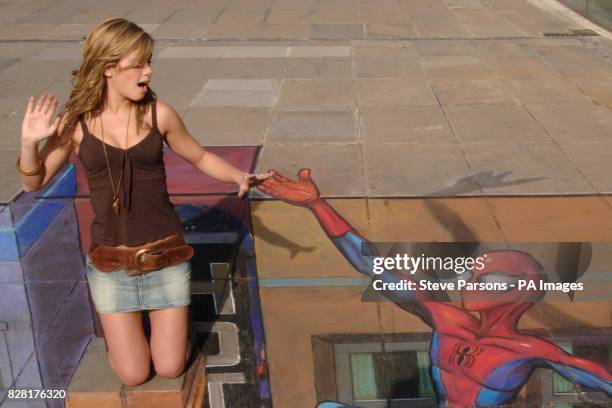 Ex-Coronation Street star Nikki Sanderson is stranded in street artist Julian Beever's 3-D cityscape at the launch of the Ultimate Spider-Man.