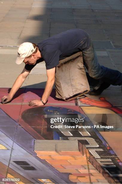 Street artist Julian Beever working on his 3-D cityscape at the launch of the Ultimate Spider-Man comic strip console game in central London, Sunday...