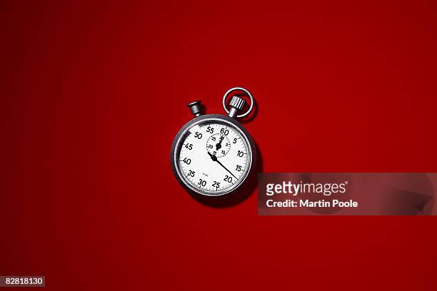 stopwatch on red background - timer stock-fotos und bilder