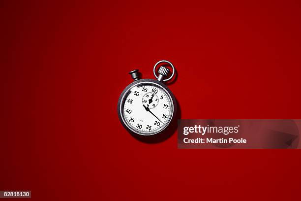 stopwatch on red background - speed accuracy stock pictures, royalty-free photos & images