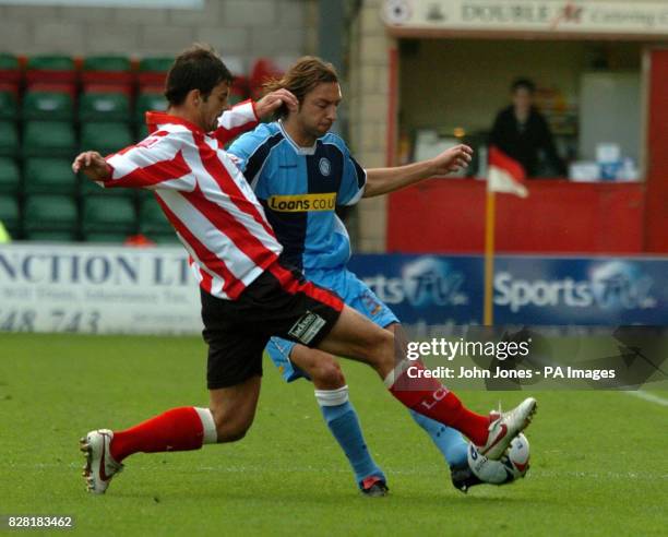 Lincoln's Richard Butcher chases the ball with Wycombe's Clint Easton during the Coca Cola League Two match at Sincil Bank Stadium, Lincoln, Saturday...