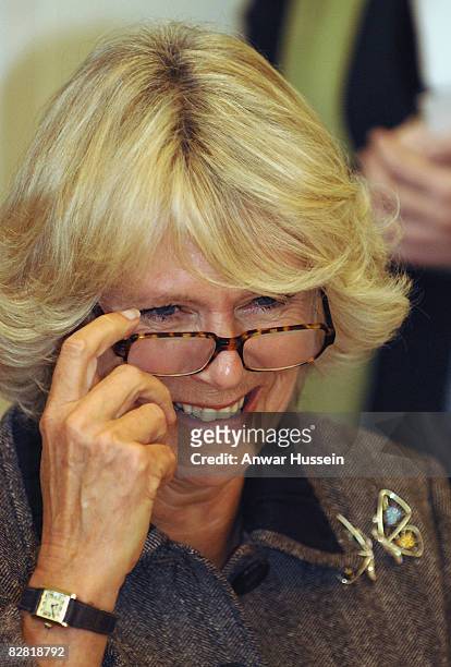 Camilla, Duchess of Cornwall puts on her reading glasses to try her hand at calligraphy during a visit to the Pound Arts Centre on October 26, 2007...