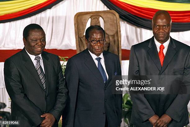 Opposition's leader Morgan Tsvangirai, Zimbabwe's President Robert Mugabe, and Zimbabwean MDC breakaway faction leader Arthur Mutambara pose after...