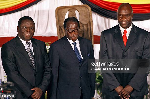 Opposition's leader Morgan Tsvangirai, Zimbabwe's President Robert Mugabe, and Zimbabwean MDC breakaway faction leader Arthur Mutambara pose after...