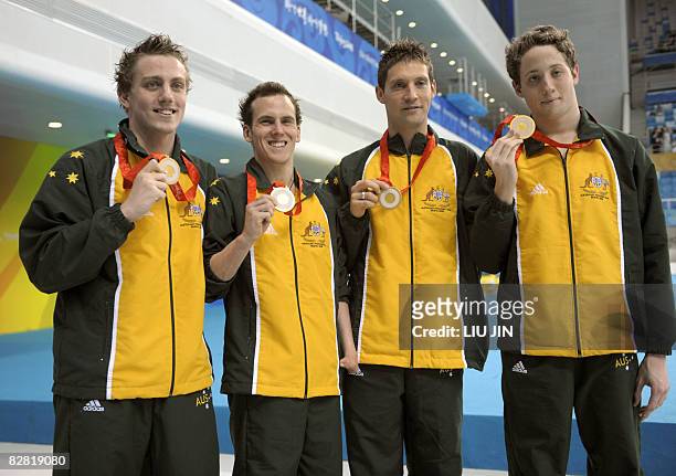 Matthew Cowdrey, Rick Pendleton, Ben Austin, Peter Leek of Australia pose with their gold medal after the medal ceremony for the men's 4x100m medley...