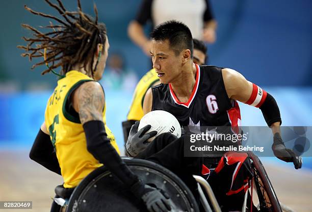 Iac Chan of Canada and Scott Vitale of Australia compete in the Wheelchair Rugby match between Australia and Canada at Beijing Science and Technology...