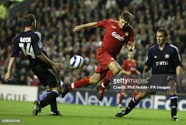 Liverpool's Steven Gerrard gets past Bart Goor and Mark De Man of Anderlecht during the UEFA Champions League Group G match at Anfield, Liverpool,...