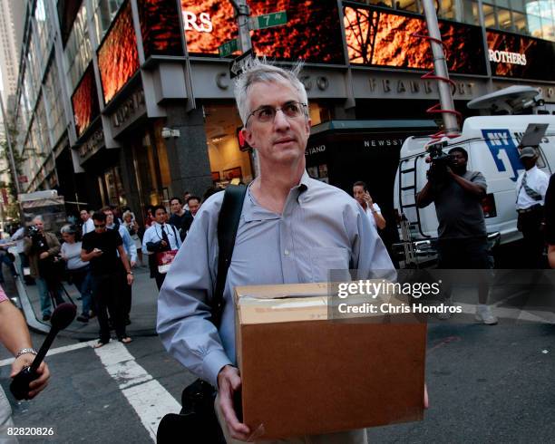 An employee of Lehman Brothers Holdings Inc. Carries a box out of the company's headquarters building September 15, 2008 in New York City. Lehman...