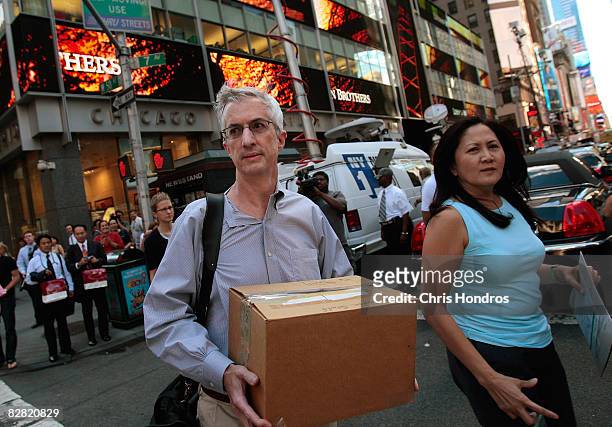 An employee of Lehman Brothers Holdings Inc. Carries a box out of the company's headquarters building September 15, 2008 in New York City. Lehman...