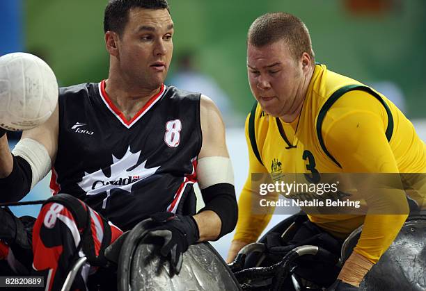 Mike Whitehead of Canada an Ryley Batt of Australia compete in the Wheelchair Rugby match between Australia and Canada at Beijing Science and...