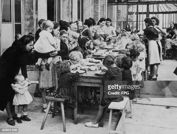 Young refugees from Dunkirk are fed by the Canadian forces during World War II, circa 1940.