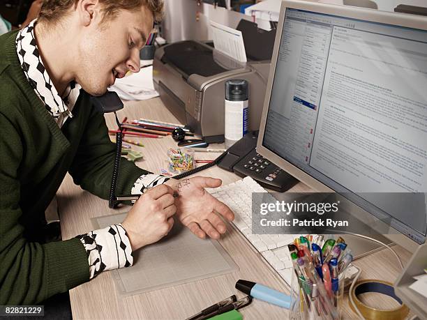 man writing down notes on his hand - desk top down view stock pictures, royalty-free photos & images