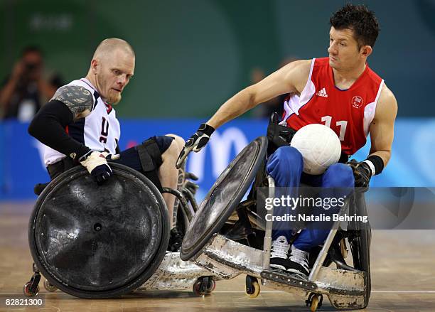 Mark Zupan of the USA rams into Alan Ash of Great Britain as they compete in the Wheelchair Rugby match between USA and Great Britain at Beijing...