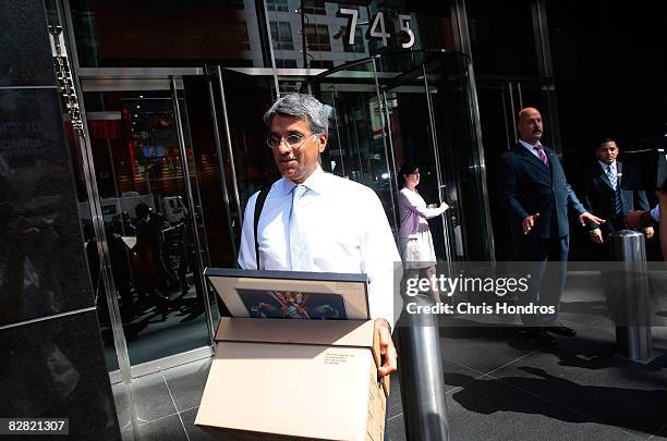An employee of Lehman Brothers Holdings Inc. Carries a box out of the company's headquarters September 15, 2008 in New York City. Lehman Brothers...
