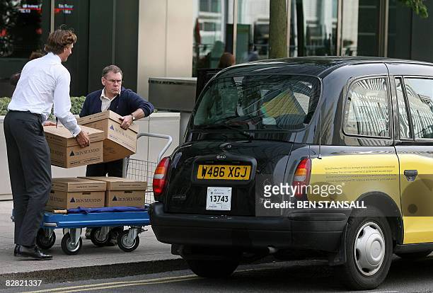 Boxes are loaded into a waiting taxi outside the Lehman Brothers European Headquarters building in Canary Wharf, east London, on September 15, 2008....