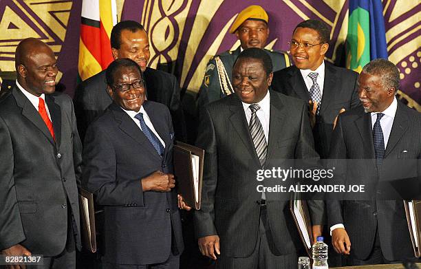 Zimbabwe's new Deputy Prime Minister Arthur Mutambara, Zimbabwe President Robert Mugabe, new Prime Minister Morgan Tsvangirai and South African...