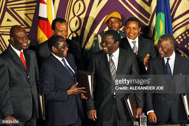Zimbabwe's new Deputy Prime Minister Arthur Mutambara, Zimbabwe President Robert Mugabe, new Prime Minister Morgan Tsvangirai and South African...
