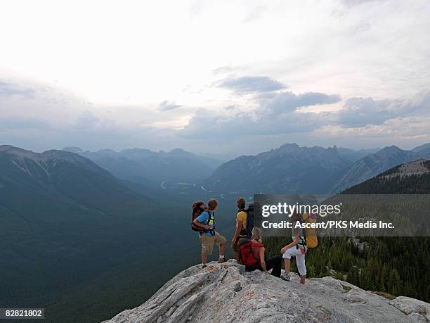 family of hikers looking at view from mtn summit - super mom stock-fotos und bilder