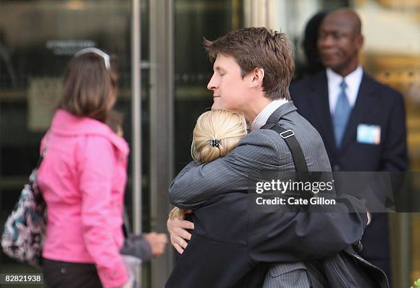 Employees comfort each other outside Lehman Brothers' Canary Wharf office on September 15, 2008 in London, England. The fourth largest American...