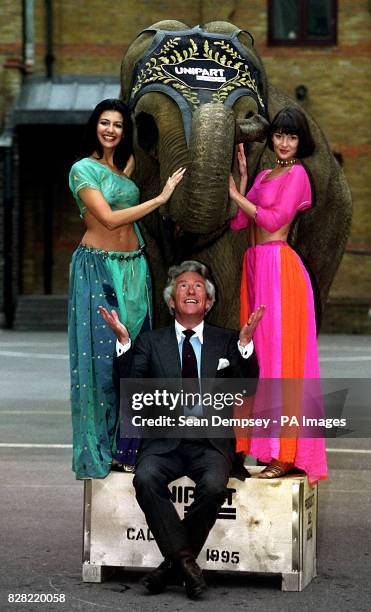 Models Kimberley Cowell , and Justine Spires pose with Lord Lichfield and Rhanee the elephant.