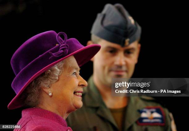 Britain's Queen Elizabeth II is shown around RAF Coltishall by Flight Lt Jason Beddall during a visit to the airbase in Norfolk, Thursday November 17...