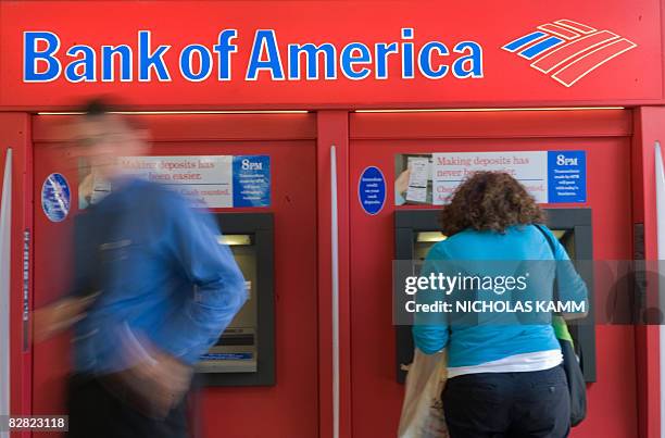 People use a Bank of America automatic teller machine in Washington on September 15, 2008. Bank of America announced earlier in the day it was buying...