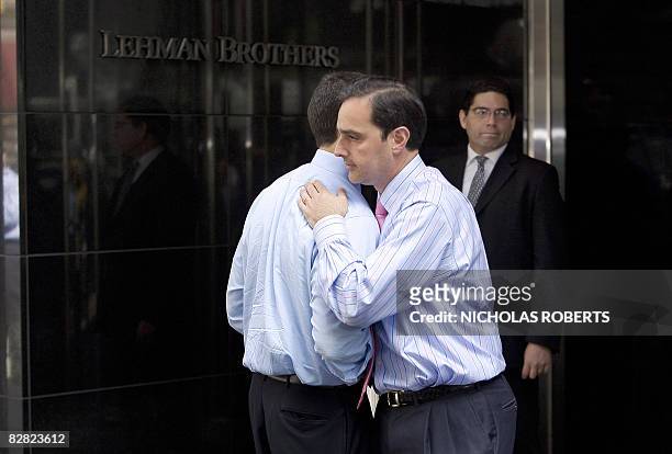 Two men hug outside of Lehman Brothers headquarters in New York on September 15, 2008. Treasury Secretary Henry Paulson said Monday that the US...