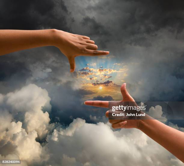 hand framing emerging sun - hope concept stock pictures, royalty-free photos & images