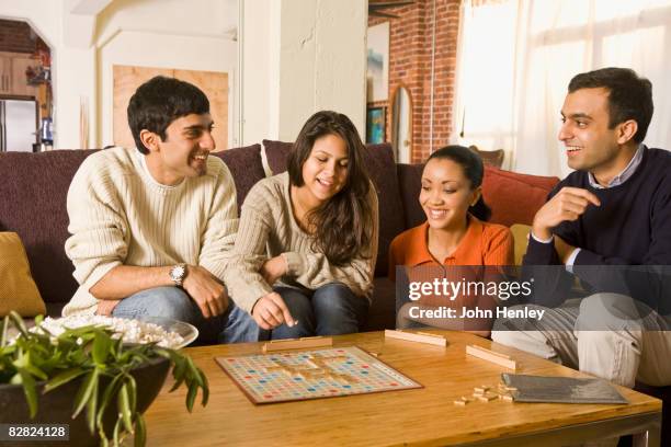 multi-ethnic family playing board game - jogo de palavras imagens e fotografias de stock