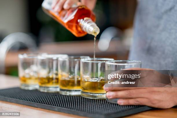 close-up on a bartender serving drinks at a bar - rum stock pictures, royalty-free photos & images