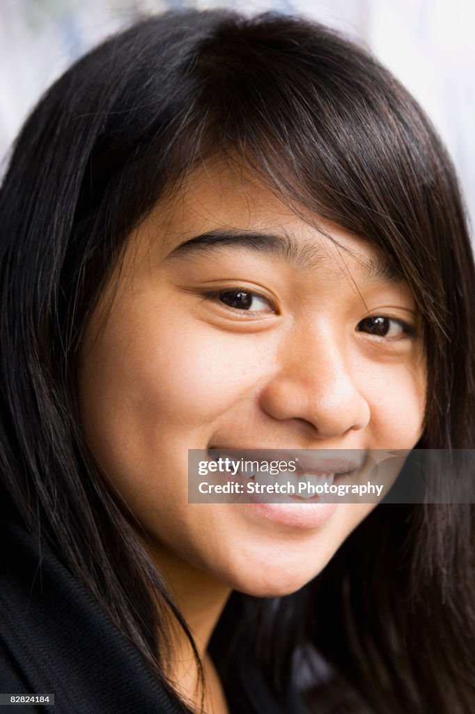 Asian teenage girl smiling