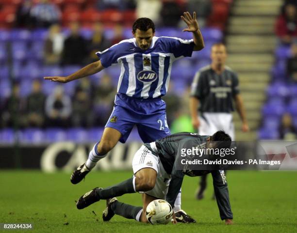 Newcastle United's Nolberto Solano is fouled by Josip Skoko of Wigan Athletic during the Carling Cup fourth round match at the JJB Stadium, Wigan,...