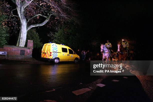 Mounted police officers ride past the scene of Anthony Walker's murder where racist graffiti was found, at McGoldrick Park, Huyton, Liverpool,...