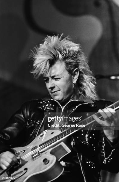 Lead singer of the rock group Stray Cats, Brian Setzer, performs during a 1987 Los Angeles, California, concert. The Stray Cats was musically a blend...