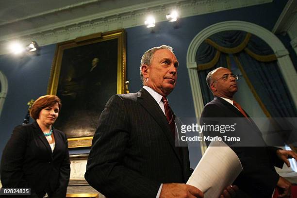 New York Mayor Michael Bloomberg departs a City Hall news conference with City Comptroller William Thompson and City Council Speaker Christine Quinn...