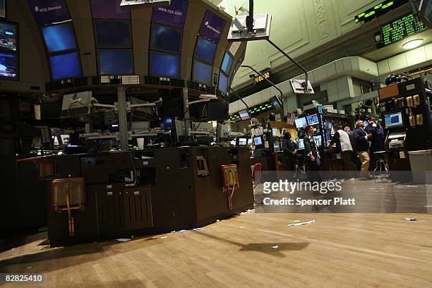 Traders work a nearly empty trading floor at the end of the day at the New York Stock Exchange September 15, 2008 in New York City. In afternoon...