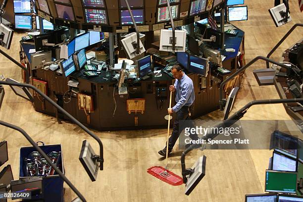 Custodian cleans up the floor of the New York Stock Exchange September 15, 2008 in New York City.In afternoon trading the Dow Jones Industrial...