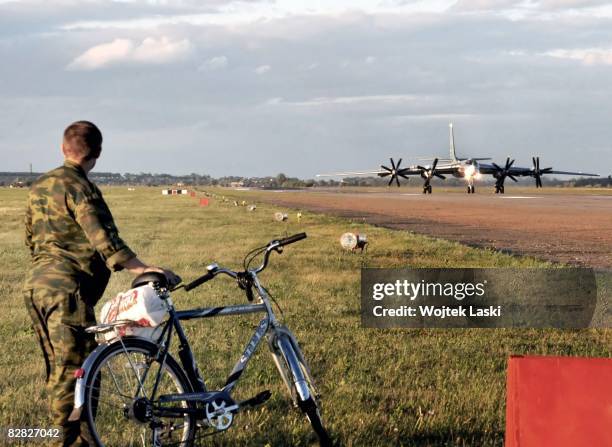 Soldier monitors the runway as a Tu-95 bomber aircraft takes off for a night patrol out of Engels-2 airbase on August 7, 2008 in Engels, Russia....