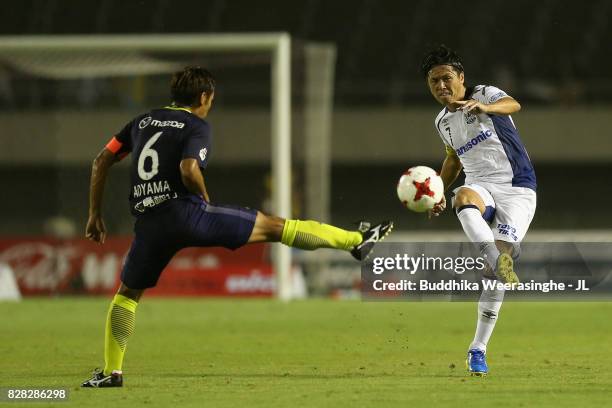 Toshihiro Aoyama of Sanfrecce Hiroshima and Yasuhito Endo of Gamba Osaka compete for the ball during the J.League J1 match between Sanfrecce...