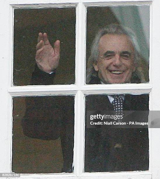 Businessman Peter Stringfellow waves to the press from a window in Richmond District Court as he awaits the decision on his application to secure a...