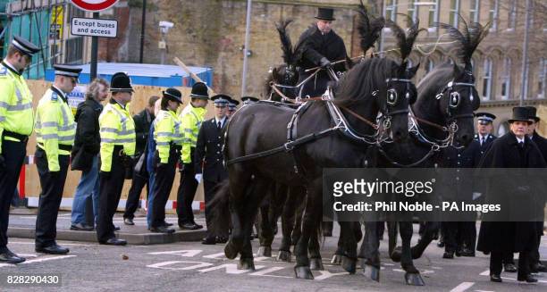 Police officers line the streets of Bradford as a horse-drawn carriage carrying the coffin of murdered police officer Sharon Beshenivsky arrives...