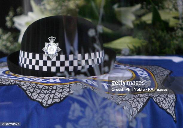 Police hat sits on top of the coffin of murdered police officer Sharon Beshenivsky which travelled through Bradford city centre in a horse-drawn...