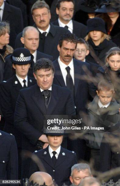 Paul Beshenivsky, husband of murdered police officer Sharon Beshenivsky, stands with the couple's children at her funeral, Wednesday, January 11 at...