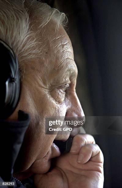 Israeli Prime Minister Ariel Sharon speaks on a helicopter microphone January 13, 2002 during a flight over Israel.