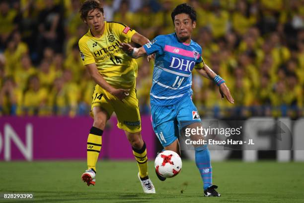 Yoshiki Takahashi of Sagan Tosu and Junya Ito of Kashiwa Reysol compete for the ball during the J.League J1 match between Kashiwa Reysol and Sagan...