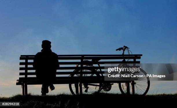 Cyclist takes a rest on Dollymount strand in Dublin Saturday January 14 2006, during a break in the winter weather. However the good weather is not...