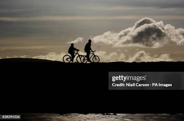 Cyclists on Dollymount strand in Dublin during a break in the winter weather.