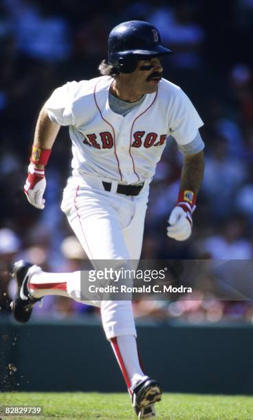 Bill Buckner of the Boston Red Sox runs to first base during a MLB game against the New York Yankees in Fenway Park on September 9, 1984 in Boston,...