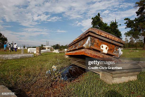 Casket rests on the open ground after floating out of its vault in the storm surge associated with Hurricane Ike September 15, 2008 in Orange, Texas....