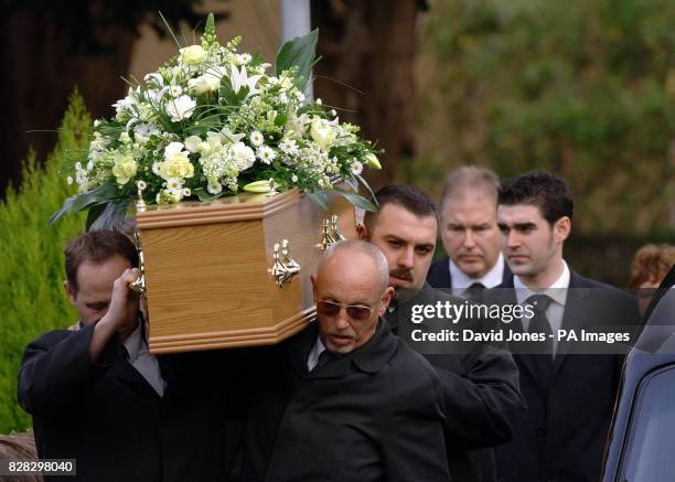 The coffin of British backpacker Katherine Horton is followed by her father Ian and brother Christopher as it is carried from the funeral service at...